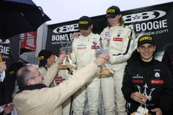 Maserati's Motorsport Director, Claudio Berro, hands the winner's trophies to Jodie Kidd and Fabio Babini in Bologna