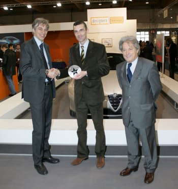 Mr. Crovero, Head of Marketing at Alfa Romeo, gets the European Automotive Design Award 2006, from Designers (Europe), during a ceremony held at the European Motor Show in Brussels.