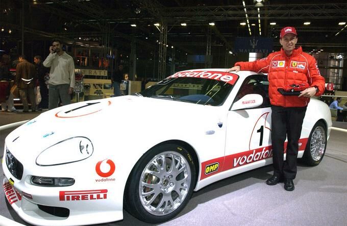Ferrari F1 test driver Luciano Burti poses with the Maserati Trofeo at the 2002 Bologna Motor Show