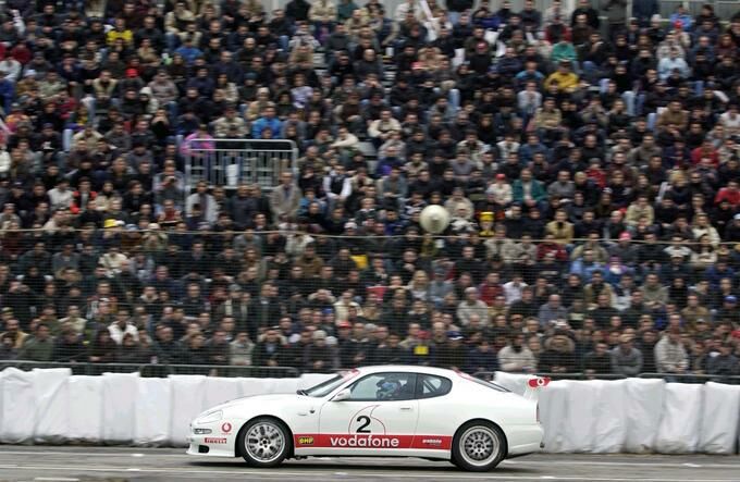 Ferrari GT tester Andrea Bertolini with the Maserati Trofeo at the 2002 Bologna Motor Show