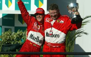 Michael Schumacher and Ross Brawn celebrate a debut victory for the new Ferrari F2002