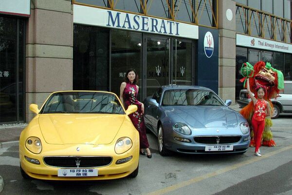 a Maserati Spyder and Coupe sit outside the new dealership in China
