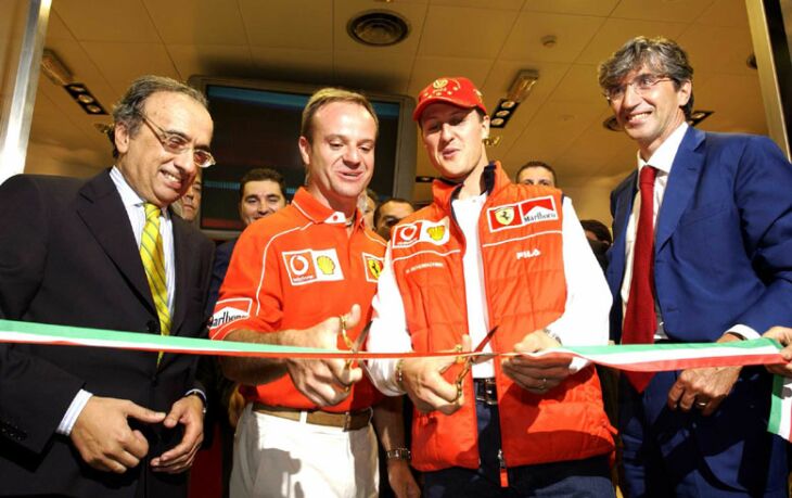 Ferrari's Formula 1 drivers, Michael Schumacher and Rubens Barrichello, perform the opening ceremony at Bologna Airport of Ferrari's first retail shop