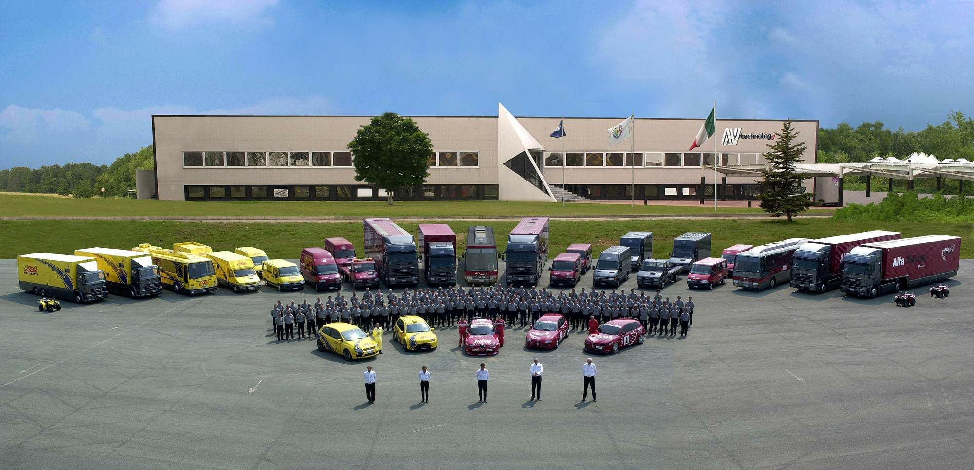 the N-Technology staff and cars pose outside the headquaters