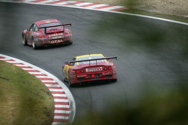 the GT class JMB Racing Ferrari 550 Maranello chases down a Porsche during the 24 Hours of Spa
