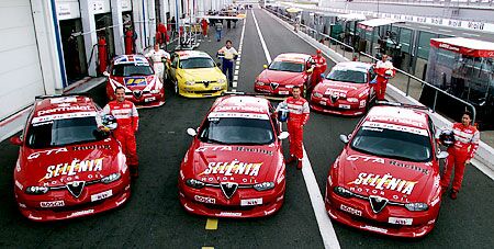 the Alfa Romeos competing in the 2002 European Touring Car Championship line up together. At the front are the three factory Nordauto Alfa 156 GTAs of Fabrizio Giovanardi, Nicola Larini and Romana Bernadoni. Behind them are the privately entered cars from DART Racing, AGS and Bigazzi. For 2003 Gabriele Tarquini and Roberto Colciago join Nicola Larini in a three car Nordauto team title challenge
