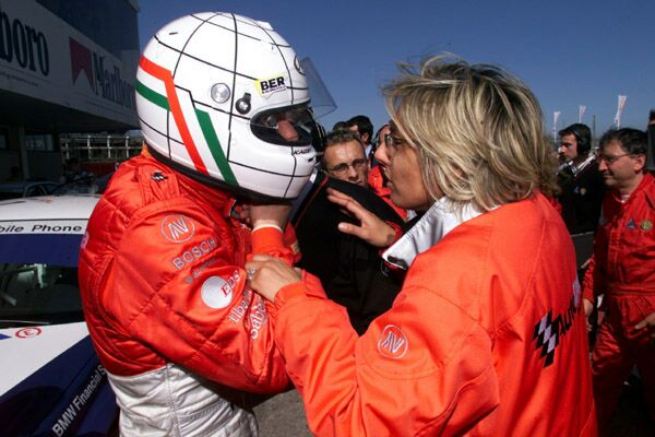 Autodelta team manager Monica Sipz congratulates Gabriele Tarquini after his race one win