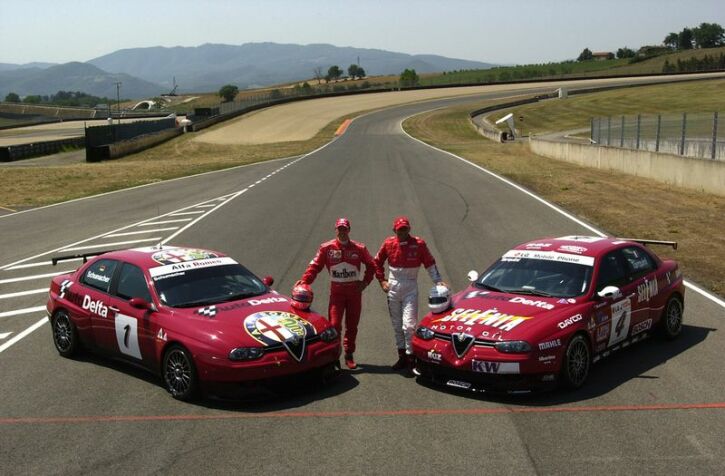 Michael Schumacher and current FIA European Touring Car Championship leader Gabriele Tarquini pose with the Alfa Romeo 156GTA