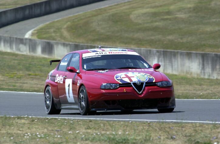 Reigning Formula 1 World Champion Michael Schumacher drives an Alfa Romeo 156GTA at Mugello