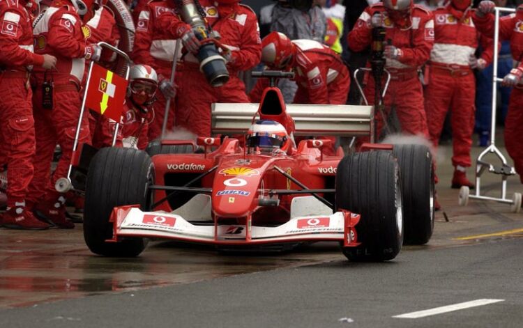 Rubens Barrichello blasts out of the pits after a scheduled pit stop
