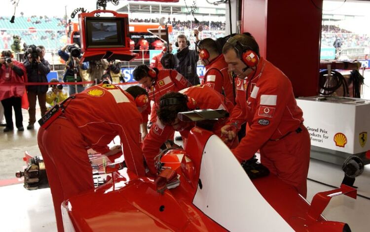 Michael Schumacher sits in the pits during qualifying