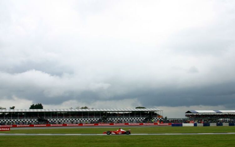 a Ferrari running through the wide open spaces of the Silverstone Grand Prix Circuit