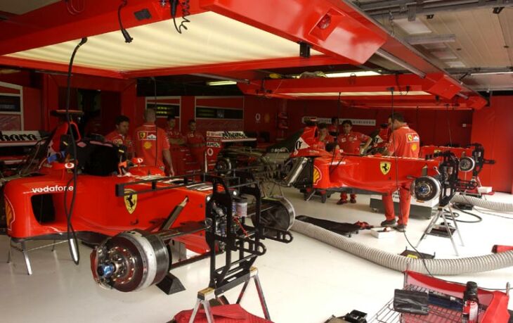 Ferrari f2002 chassis sit in the pit garage awaiting the start of qualifying