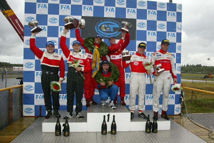 the victorious Ferrari drivers, Andrea Piccini and Jean-Denis Deletraz on top of the winners podium