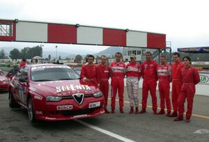 the six young Italian Touring Car drivers invited to test the Nordauto Alfa Romeo 156 GTA pose with factory drivers, Nicola Larini and Fabrizio Giovanardi
